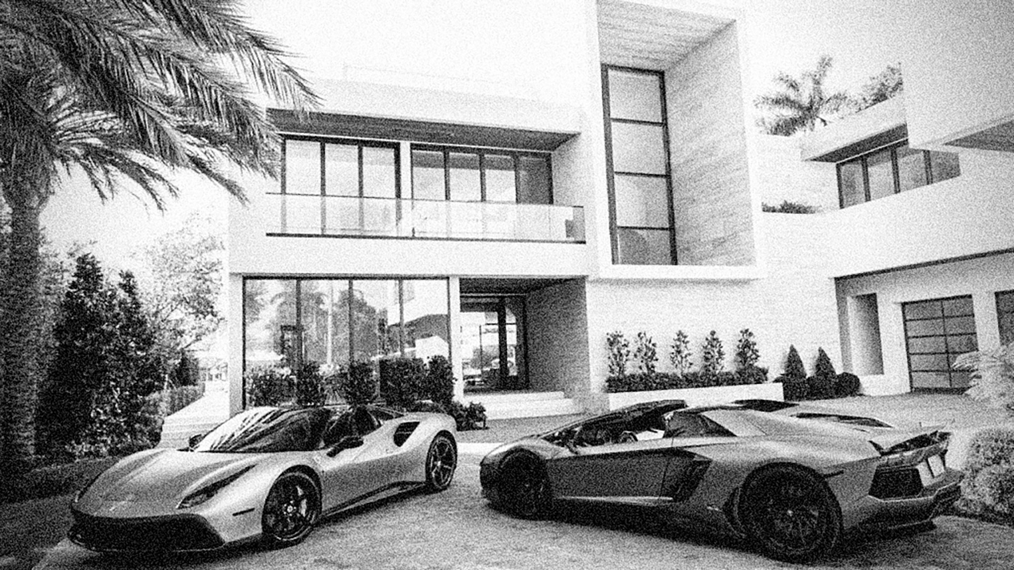 Private residence with luxury vehicles in the driveway