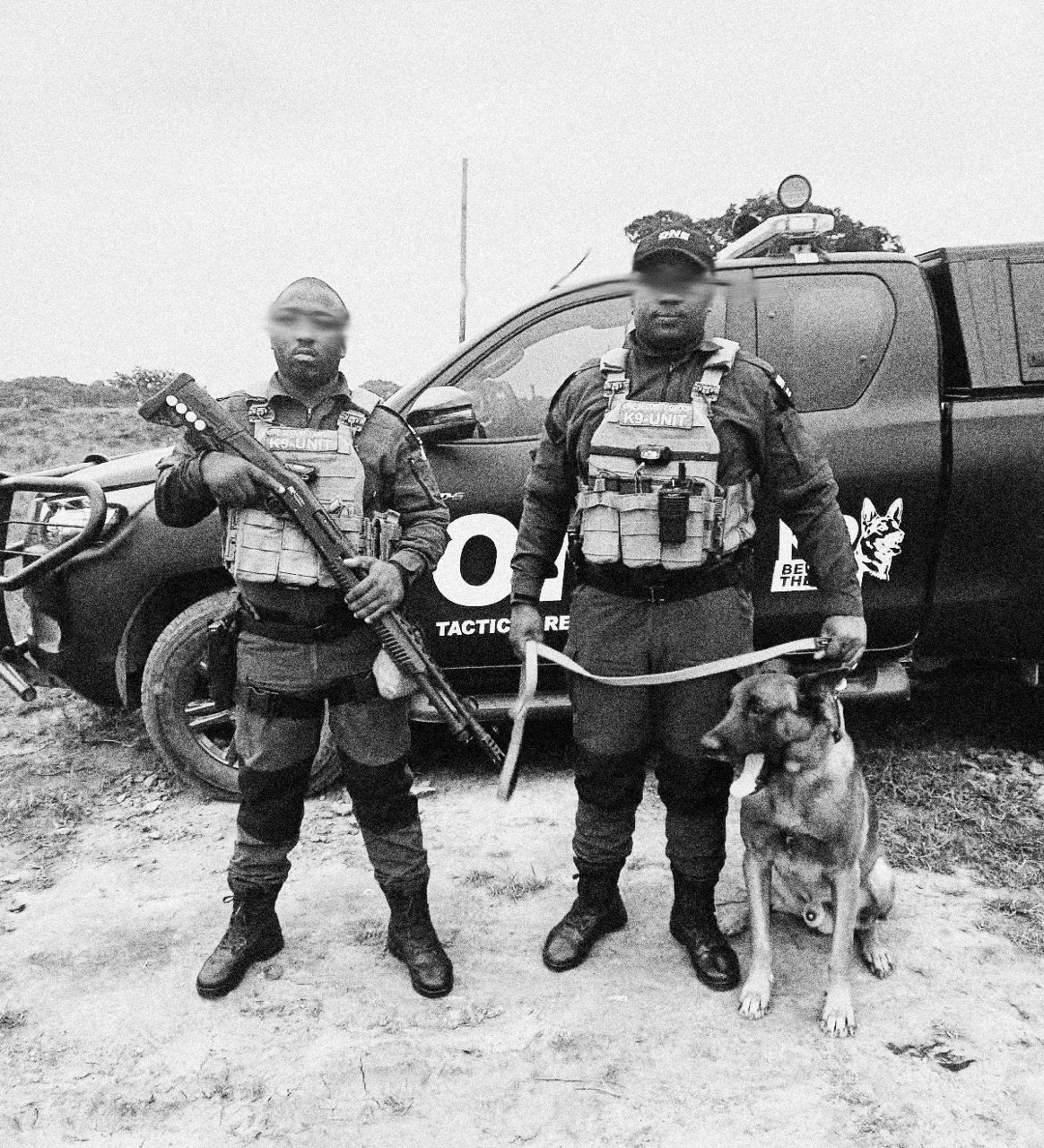 ONE tactical officer and K9 handler with a man-trailing K9 beside a Tactical Response vehicle