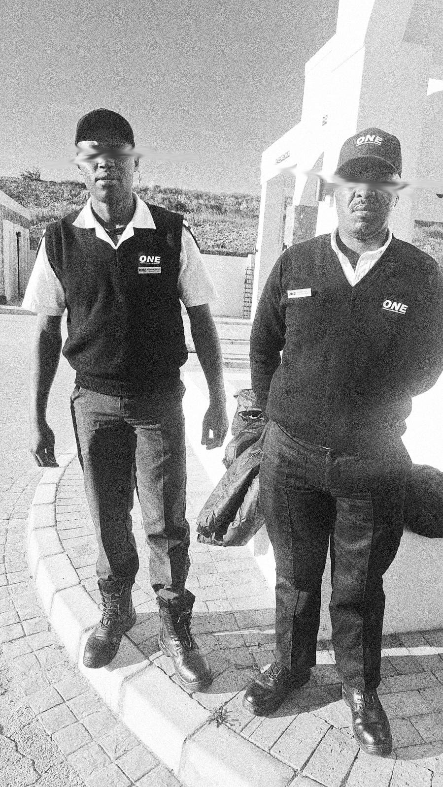 Two ONE security officers in uniform at a residential estate entrance