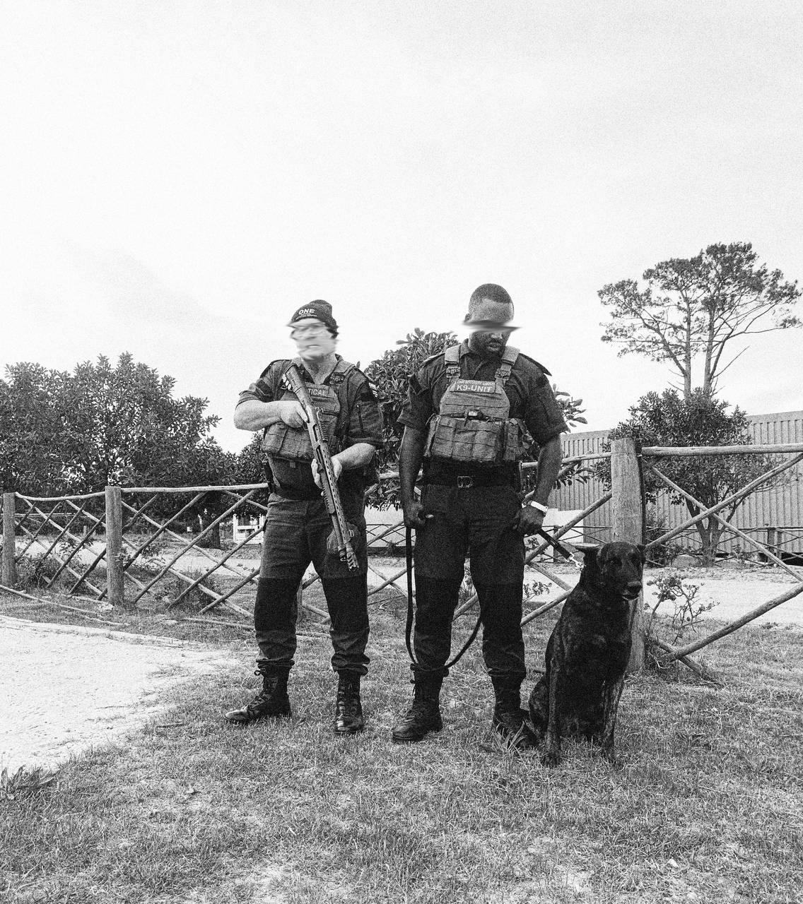 ONE tactical officer and K9 handler with a Malinois at an estate gate